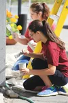 Rebeka Hazleton of New York and Deliesha Gonzales of Arizona paint the exterior of MY House in Wasilla Monday. The two are part of a group of 39 volunteers working on service projects in the 