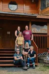 Staff at Talkeetna radio station KTNA pose on the steps of their Talkeetna headquarters last summer. Seated from left, Jenny Willoughby, Christie Seay, and Trisha Costello. Standing from left
