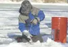 Nickolas Stevens, 5, scoops ice from his fishing hole. (ROBERT
DeBERRY/Frontiersman)