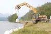 TODD DISHER/Frontiersman It took heavy equipment to place these
large sand bags Friday morning along the bank of the Matanuska
River near Mile 63.5 of the Glenn Highway.
