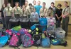 Mika Hoage assembled 64 backpacks filled with coloring books and crayons, journals and pencils, sippy cups and various sizes of clothing ranging from infant to teenager to give to children in