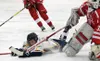 Homer's Tim Blakely slides into Wasilla goaltender Aaron Campbell Friday in a North Star Conference tournament semifinal at the Soldotna Regional Sports Complex. (Photo by Joey Klecka/Peninsu