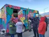 Valley resident Lacey Eshleman participates in an interview for the Food Network's "The Great Food Truck Race" series in downtown Palmer.