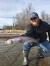 Spencer Cook with a dandy holdover Finger Lake rainbow trout he caught at the boat launch.