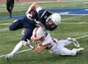 Soldotna's McKade Moore is tackled by Wasilla's Adam Corneliussen on Friday, Sept. 19, 2025, at Justin Maile Field at Soldotna High School in Soldotna. Jeff Helminiak/Peninsula Clarion