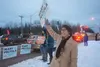 Rep. Mary Peltola waves campaign signs at passing motorists in East Anchorage on the morning of Election Day. The sealskin and otter-fur hat she is wearing was a gift from friends in Juneau. 