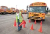 First Student driving trainer Jessie Laub-Elkins sets up cones in a mirror grid formation for new bus driver Jeff Hoffman Monday afternoon. Hoffman was just beginning his driver training. Beg