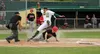 Mat-Su pitcher John Doxakis falls over Peninsula Oilers outfielder Thomas Ruddy after Doxakis reached up to snag a high throw as Ruddy slides into home to score the go-ahead run during a 2-1 
