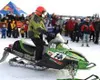 Marc McKenna crosses the finish line on his Arctic Cat
snowmachine at the Call of the Wild on Big Lake Saturday as his
many fans await to congratulate him. GENE JANSEN/For the
Frontiersman
