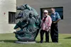 Artists Jacques and Mary Regat stand in front of their old statue with a new home. Courtesy photo by Lana Regat