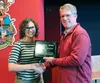 Amara Liggett, grill manager at Bear Tooth Theaterpub, receives the Buy Local Award from Mat-Su Farm Bureau President Don Berberich Feb. 24. Courtesy Taylor Berberich