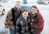The Swanson family — Ben, Natalie and Tara — stand in front of the car they received through the Wheels of Hope program Friday. The couple received a 2001 Dodge Stratus. ROBERT DeBERRY/Fronti