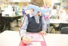 ROBERT DeBERRY/Frontiersman Shaw Elementary kindegarten student
Devin Biggs puts a finishing touch on a valentine card that is
going to be sent to U.S. troops deployed overseas.