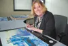 Artist Linda Henning signs copies of her 2010 winning Mat-Su
Borough poster of the M/V Susitna. Courtesy photo