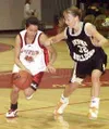 Houston's Britnee Lapham drives the ball around Nikiski's Sally
Glaze in the second quarter of Friday's game. Photo by TIM
BRODT/Frontiersman.