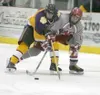 Wasilla sophomore Spencer Galvin battles with a Lathrop
blueliner for the puck during the third period of the Warriors' 5-1
loss to the Malemutes in nonconference hockey action at the Curtis
