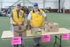 Members of the Lions Club were among those who volunteered during the fifth annual Stuff the Bus event at the Menard Sports Center in Wasilla. Tim Rockey/Frontiersman