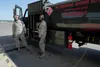 Senior Airman Jessica Wilt, left, and Airman 1st Class Anthony Moncrief, both assigned to the 673d Logistics Readiness Squadron, refuel an F-22 Raptor of the 525th Fighter Squadron (the Bulld