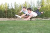 Daniel Dahms and Brian Dahms dive for the disc while playing Ultimate Frisbee at the Sherrod field recently. Brian Dahms is organizing a local Ultimate Frisbee league. Those interested in par