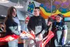 Michelle Overstreet, left, and Kurt Hoenack celebrate the ribbon cutting and re-opening of Gathering Grounds Cafe on February 1. Also pictured are several of the many youth staff who find edu