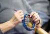 Primrose Granny member Nancy VanLoon works on a project during a
knitting group gathering Tuesday afternoon. The knitting club
members make newborn hats that they donate to the maternity ward
