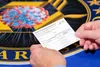 A Department of Health and Human Services employee holds a COVID-19 vaccine record card Nov. 13, 2020, in Washington D.C. The cards will be sent out as part of vaccination kits from Operation
