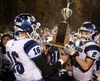 Palmer High sophomores Nolan Garner and Corbin Gerkin raise the Mayor's Cup following a 14-7 win over Wasilla in the Potato Bowl. Bruce Eggleston/matsusports.net