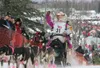 (ROBERT DeBERRY/Frontiersman) DeeDee Jonrowe waves to cheering
fans as she begins her 1049 mile trip to Nome Sunday at the start
of the 38th Iditarod in Willow.