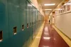 The halls are lined with lockers and portraits of elders at the Anna Tobeluk Memorial School in Nunapitchuk, Alaska. October 12, 2023.  Claire Stremple/Alaska Beacon