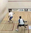 Mark Alger (left) sends a shot along the wall against Englishman
Adrian Williams in Alger's first match in the Melbourne 2001
International Squash Festival. Submitted photo.