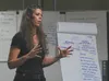 Retired Anchorage Police officer Wendi Shackelford talks to state troopers, court system staff and health services employees at the end of an eight-hour mental health first aid course at Stat