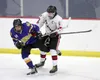 Houston captain Jaden Sears pushes Monroe's Garreit Grahek away from the puck during a 4-0 win over the Rams Friday. MatSuSports.net