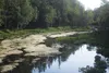 Cottonwood Creek meanders south toward East Glenwood Avenue Friday. The creek has been listed as an impaired water body due to the presence of fecal bacteria. A local company working with a s