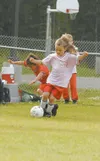 ROBERT DeBERRY/Frontiersman Samantha Cooper, 5, steals the ball
from the opossing team Thursday evening during a Wasilla Youth
Soccer Association game at Shaw Elementary.