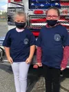 Big Lake Elementary third grader girls Erabella Hunt and Lily Caven stand in front of an emergency response vehicle after being honored as heroes for helping save a man's life. Courtesy photo