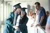 (ROBERT DeBERRY/Frontiersma) 2009 Colony High School graduates
James McRea and Dalton Harrison rush to catch up to the rest of the
graduating class after stopping to hug friends and relatives