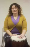 Dr. Meggie Aube sits at the ready to play one of her many hand drums in her new studio between the Palmer Bar and Midnight Sun Yoga Center on Colony Way. A grand opening celebration is Saturd