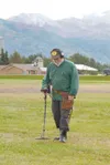 VICKI NAEGELE/For the Frontiersman Retired postal worker Paul
Hunkel of Palmer scans the ground outside the Alaska State Fair
looking for lost change and valuables. His detector can tell him
