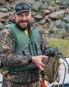 Susitna Rotary Presiden Aaron Coman pulls the trash from his canoe that he collected from the river during Saturday's event J. David McChesney/Frontiersman