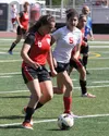 Kenai's Cassie Holmes and Wasilla's Merit Paramo race up the field during Kenai's 2-1 win over Wasilla. Jeremiah Bartz