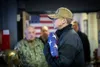 U.S. Navy Reserve Yeoman 2nd Class Mathew West cradles the U.S. flag while participating in a remembrance ceremony at the U.S. Navy Reserve Center on Joint Base Elmendorf-Richardson, Alaska, 