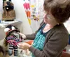 Nan Mucha works to set up Arts and Crafts entries inside the
Irwin Exhibit Hall Monday afternoon. There are close to 900 entries
this year. ROBERT DeBERRY/Frontiersman