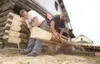 ROBERT DeBERRY/Frontiersman Rich Greeno, left, and Louis Winkler
cut logs for the blacksmith shop at the old Wasilla townsite
Thursday afternoon.