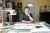Tundra cartoonist Chad Carpenter sits at his desk in his Wasilla home. Carpenter’s comic strip recently entered its 500th newspaper, a big milestone for Carpenter and the rest of the Tundra t