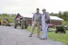 Mike Dewan of D and D Auctions and Ted Berry stand in the
farmyard at Birch Grove Farm Tuesday. The Berrys spent the past 20
years carving the farm out of the wilderness at Mile 79 of the
Par