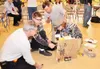 TIM LUNDT/Courtesy photo Brandon Olson and Jonah Jefferies of
Mat-Su Career and Technical High School build a project during the
recent Science Olympiad event. A pair of judges look on as the