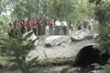 Large boulders and blue and yellow tape mark the site of an illegal stream crossing that Alaska Intern Crew volunteers restored last week. About 70 linear feet of severely impacted stream ban