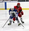 Palmer forward Hayden Moistner tries to pull the puck away from Wasilla's Adam Apangalook during a 5-0 win over Palmer Friday. BRUCE EGGLESTON/matsusports.net