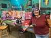Judy Vars welcomes visitors to the Art Cafe, standing in front of her dream like paintings. Russell Clark/For the Frontiersman