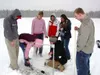 Sabrina Henry cleans snow away from an ice thickness gauge on
Lake Lucille, with a hamburger flipper -- "a true scientific
instrument!" The ice was about 70 cm thick this day. Looking on are
